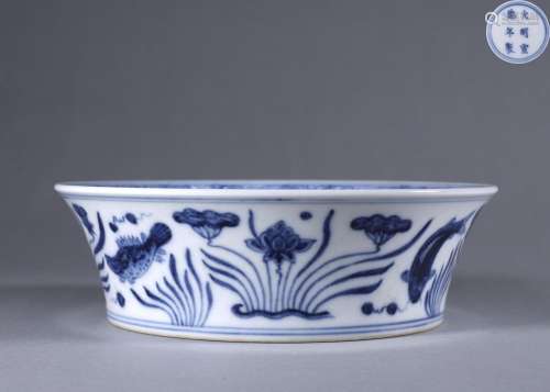 A blue and white fish and seaweed porcelain washer