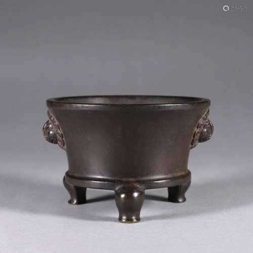 A three-legged copper censer with lion shaped ears