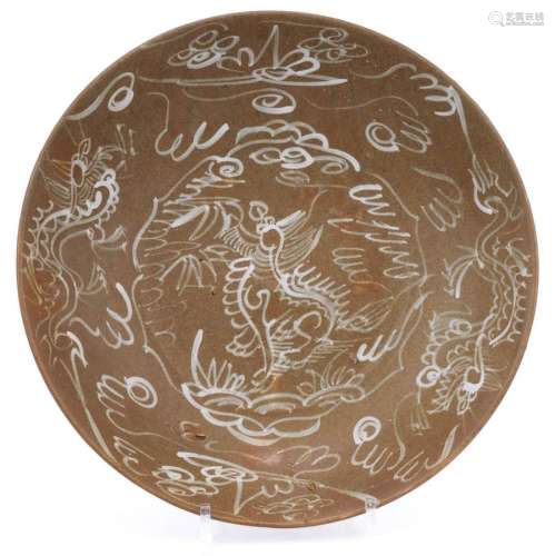 A brown Swatow dish with slip decoration