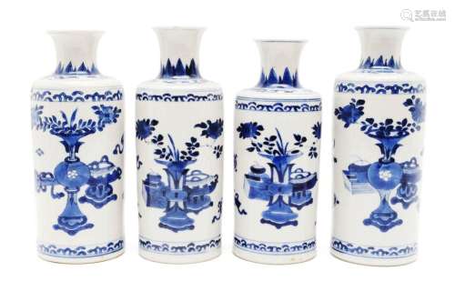 Four blue and white cylindrical vases