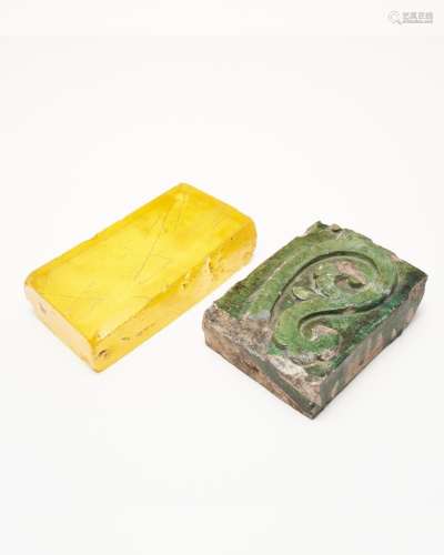 A green-glazed architectural brick, and a yellow glass brick...
