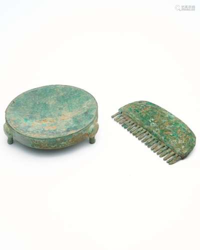 A bronze comb and a tripod inkstone the inkstone possibly Ea...