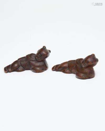 A pair of 'reclining boy' bronze brushrests and pape...