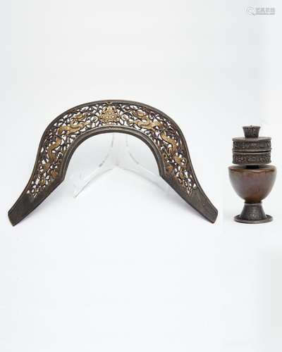 An iron pommel plate from a saddle, and a silver and copper ...