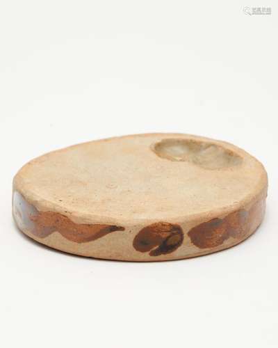 A small Huangbao-ware round porcelain inkstone painted in br...