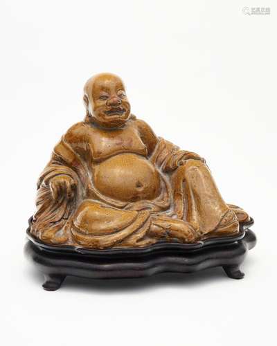 A shiwan-ware yellow glazed figure of Buddha 19th/20th centu...