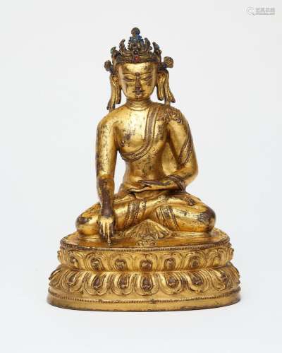 A gilt copper alloy figure of crowned Buddha Tibet, 15th cen...