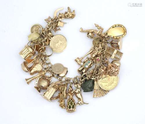 A gold charm bracelet, made up of 10kt & 14kt gold charm...