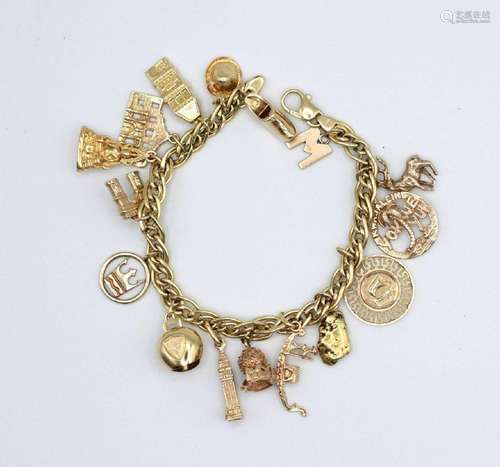 An 18kt yellow gold charm bracelet with 14kt yellow gold cha...