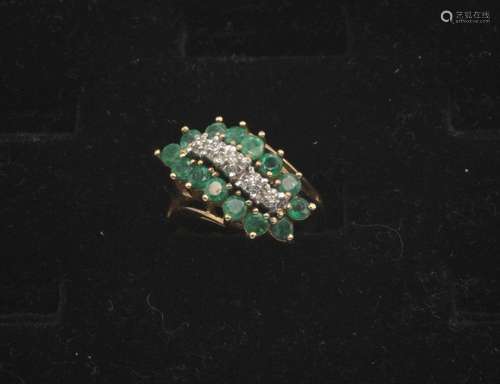 A lady's emerald and diamond cocktail ring in 10kt yellow go...