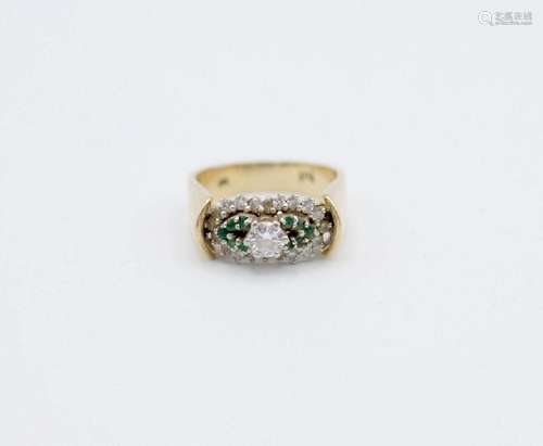 A lady’s 18kt yellow gold, diamond, and emerald ring