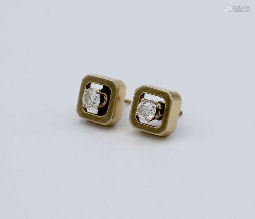 A pair of diamond stud earrings with 14kt yellow gold square...