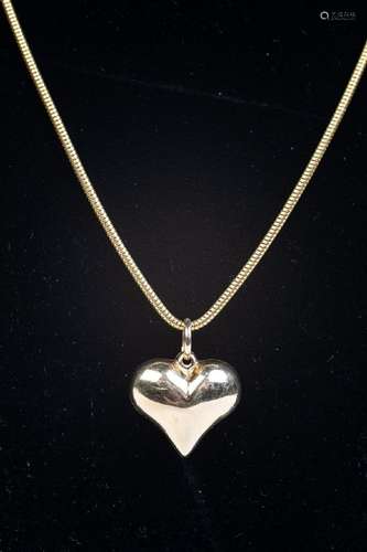 An 18kt yellow gold necklace with heart shaped pendant.