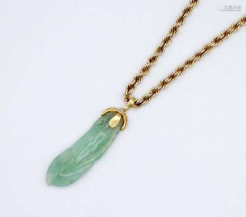 A carved Chinese jadeite pendant attached to a 10kt yellow g...