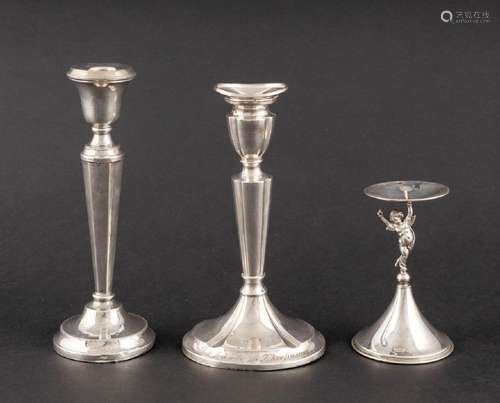 Three silver candlesticks