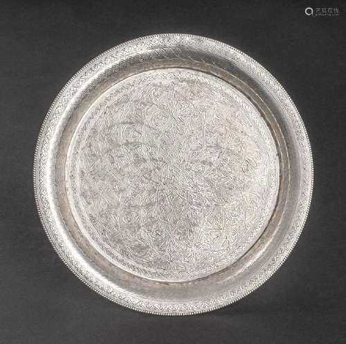 An Iranian silver salver finely chased with flowers and trel...