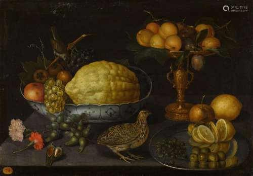 Still life of a citron, grapes, an apple and other fruits in...