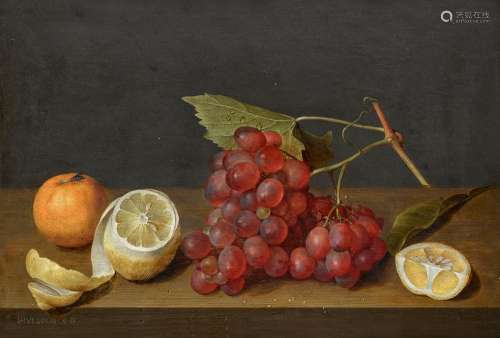 Still life with a bunch of grapes and a peeled lemon on a le...