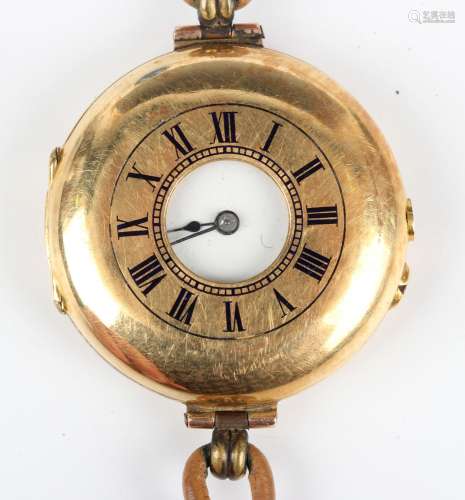 An 18ct gold circular half hunting cased wristwatch, the uns...