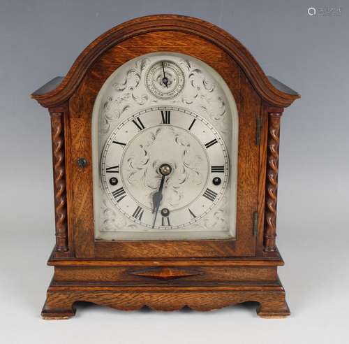 A George V oak mantel clock with eight day movement chiming ...