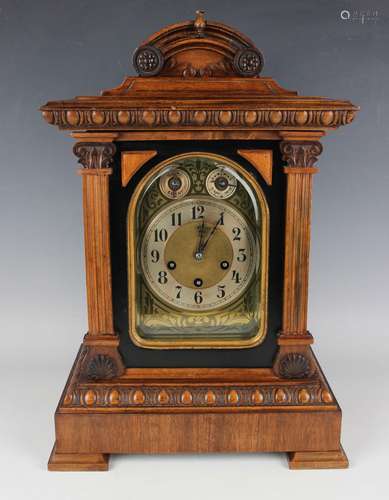 A late 19th century walnut cased mantel clock with Junghans ...