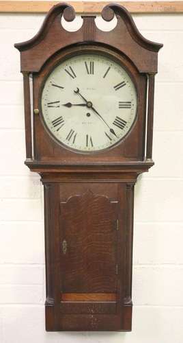 A mid-19th century oak trunk dial wall clock timepiece with ...