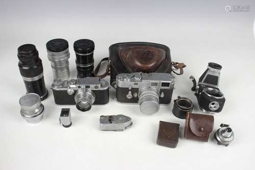 A collection of Leica cameras and accessories, including an ...