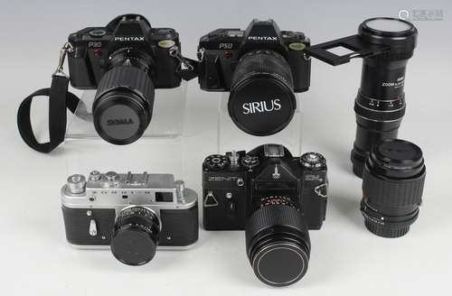 A collection of cameras and accessories, including a Pentax ...