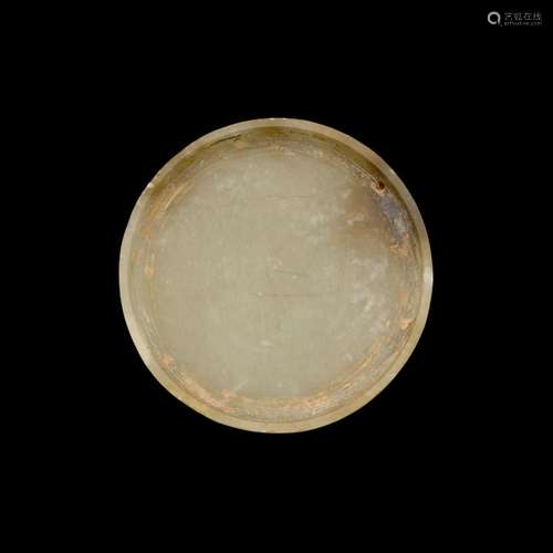 A jade circular appliqué, Han dynasty | 漢 玉飾