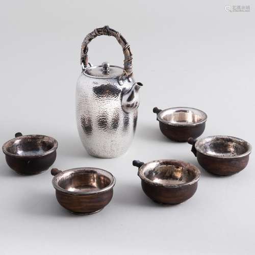 Japanese Hammered Silver Sake Ewer, Five Wood Sakazuki and a...