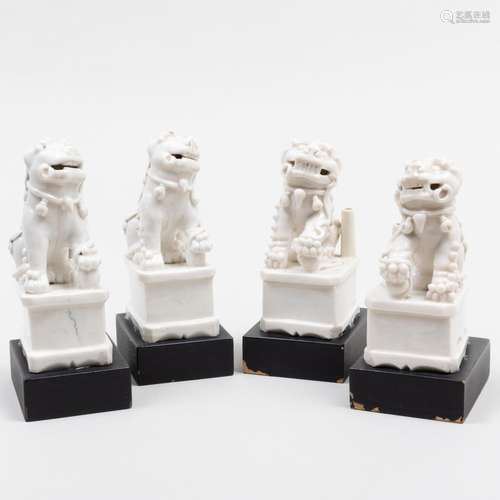 Group of Four Chinese White Glazed Porcelain Buddhistic Lion...