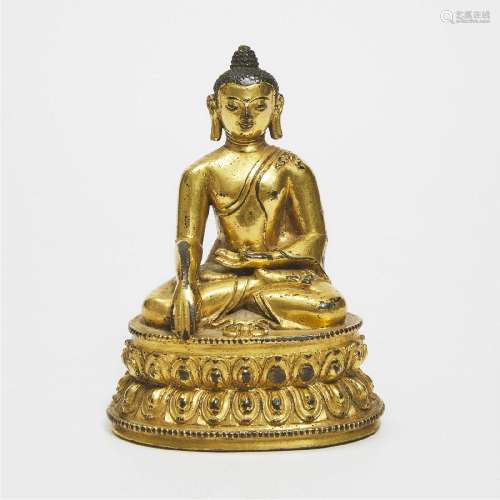 A Gilt Copper Alloy Figure of Seated Shakyamuni Buddha, Tib