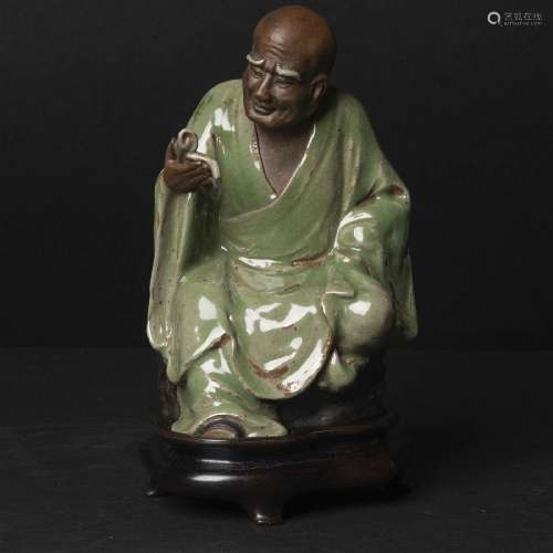 A Shiwan-Glazed Pottery Figure of a Luohan, Qing Dynasty, ?