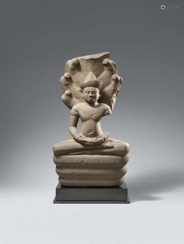 An impressive Khmer sandstone figure of a crowned and bejewe...