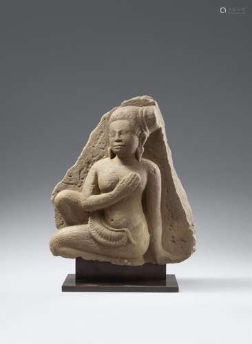 An Angkor Wat-style sandstone figure of a female attendant. ...