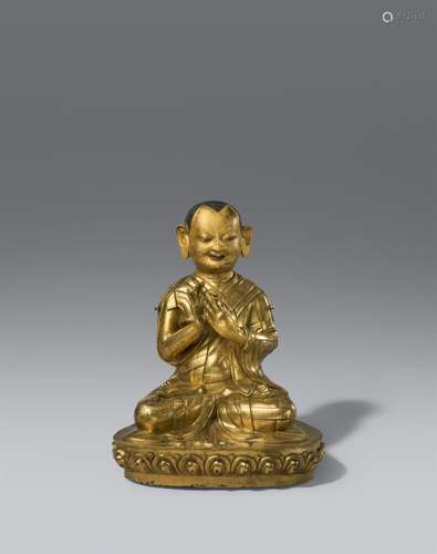 A large gilt bronze figure of a lama. Tibet, 17th/18th centu...