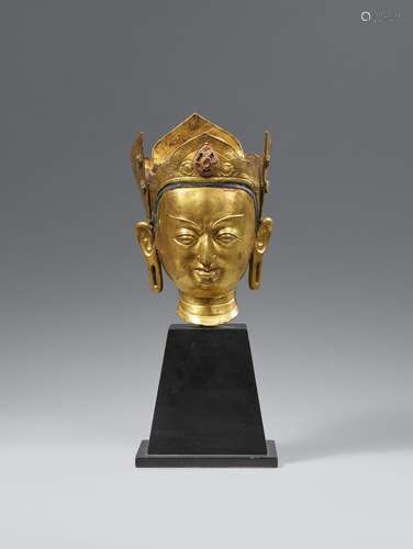 A fire-gilt bronze head of Padmasambhava. Tibet. 18th centur...