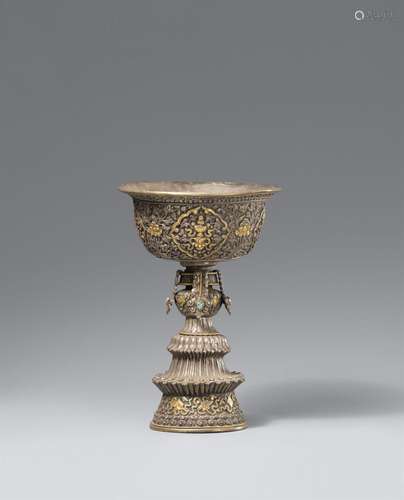 A bajixiang repoussé butter lamp (offering lamp). Tibet, 19t...