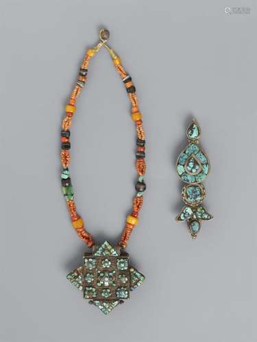 A woman`s necklace with a turquoise-inlaid amulet box (ga`u ...