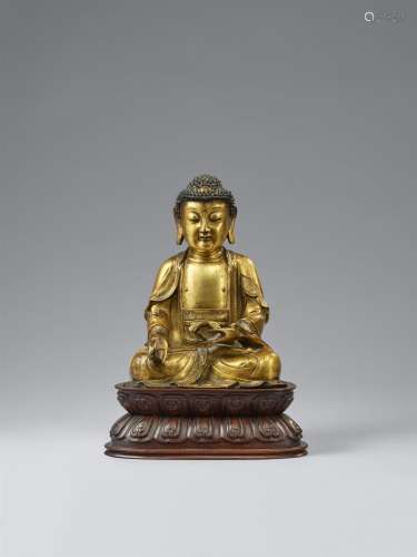 A gilt-bronze figure of the Medicine Buddha. Ming dynasty, 1...