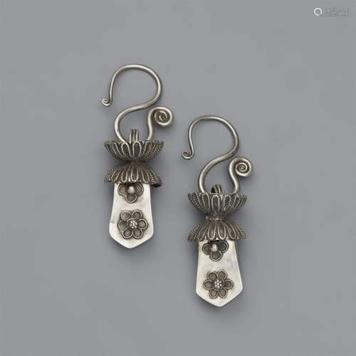 A pair of ear hangings. Southern China, Guizhou province. Mi...