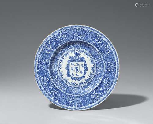 A large blue and white armorial dish with the arms of the Co...