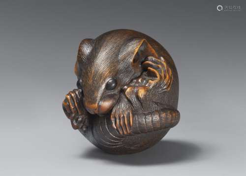 A Yamada school boxwood netsuke of a coiled rat. 19th centur...