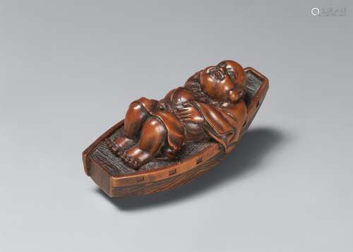 A boxwood netsuke of Hotei resting in a boat. Late 19th cent...