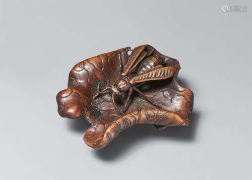 A boxwood netsuke of a wasp on a lotus leaf. 20th century