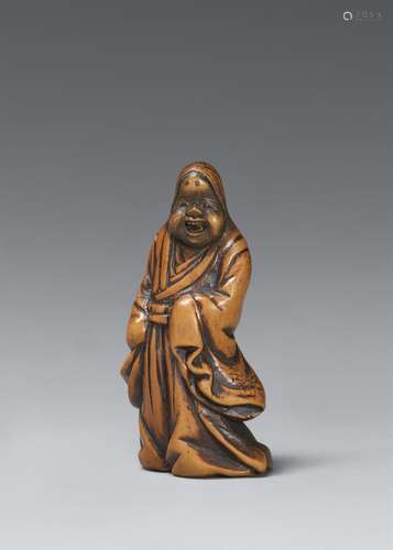 A boxwood netsuke of a jolly Okame. 19th century