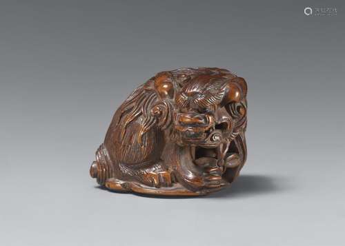 A boxwood netsuke of a howling shishi. 19th century