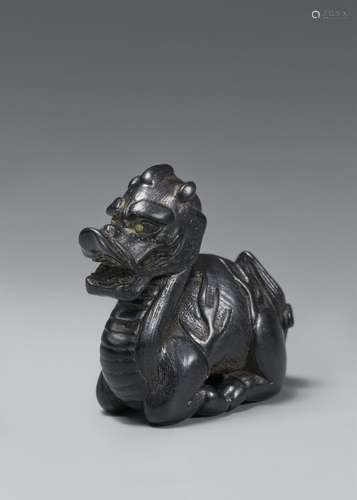 A blackwood netsuke of a seated kirin. 19th century