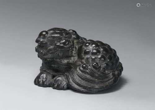 A kokutan netsuke of a reclining shishi. 19th century