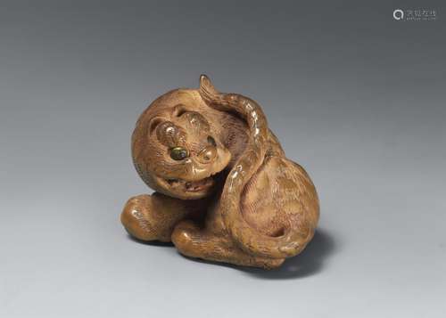 A light boxwood netsuke of a tiger. 19th century